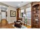 Cozy sitting room with a comfortable chair, bookshelves, and plenty of natural light at 610 W Tonto Dr, Chandler, AZ 85248