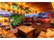 Backyard patio with ambient lighting, outdoor seating, and vibrant, lush garden at 6338 E Camelot Dr, Mesa, AZ 85215