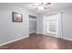 Minimalist bedroom with ample closet space, hardwood floors, and a bright window for natural light at 6338 E Camelot Dr, Mesa, AZ 85215