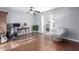 Bedroom with hardwood floor, stylish chair, desk, and bright window at 6338 E Camelot Dr, Mesa, AZ 85215