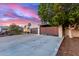 A modern single-story home boasts a wide driveway, a two-car garage, and a secluded courtyard entrance at 6338 E Camelot Dr, Mesa, AZ 85215