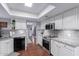 Modern kitchen features granite countertops, stainless steel appliances and a skylight for natural light at 6338 E Camelot Dr, Mesa, AZ 85215