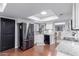 Well-lit kitchen featuring granite countertops, stainless steel refrigerator and convenient breakfast bar at 6338 E Camelot Dr, Mesa, AZ 85215