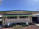 Single-story home featuring a covered front yard with desert landscaping and a covered carport at 7300 N 51St Ave # G142, Glendale, AZ 85301