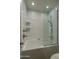 Bright, white bathroom features tiled shower and tub with glass partition and silver fixtures at 7350 N Via Paseo Del Sur -- # N108, Scottsdale, AZ 85258