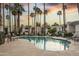 Sparkling community pool surrounded by palm trees and lounge chairs, perfect for relaxation at 7350 N Via Paseo Del Sur -- # N108, Scottsdale, AZ 85258