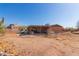 Backyard featuring a single-story home with a covered patio, desert landscaping and a car parked outside at 765 S Geronimo Rd, Apache Junction, AZ 85119