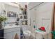 Bright bathroom with a shower featuring a chair, vanity, storage shelves, and sink at 765 S Geronimo Rd, Apache Junction, AZ 85119