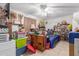 Cozy bedroom featuring a ceiling fan, comfortable bed, and plenty of storage shelves for personal belongings at 765 S Geronimo Rd, Apache Junction, AZ 85119