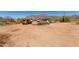 Exterior view of desert property showing parking and mountain backdrop at 765 S Geronimo Rd, Apache Junction, AZ 85119