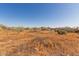 View of the property, showing desert landscaping, vehicles and surrounding area at 765 S Geronimo Rd, Apache Junction, AZ 85119