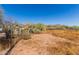 Spacious desert yard with sparse vegetation, fence line and mountain view at 765 S Geronimo Rd, Apache Junction, AZ 85119