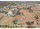 Expansive aerial shot features a home with pool, desert landscaping and white fence in a rural community at 8715 S Valley Vista Ct, Casa Grande, AZ 85193