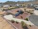 Stunning aerial view showcases a spacious home with desert landscaping and a charming white fence at 8715 S Valley Vista Ct, Casa Grande, AZ 85193