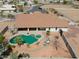 Aerial view of backyard oasis, showcasing pool, spa, patio space, and desert landscape at 8715 S Valley Vista Ct, Casa Grande, AZ 85193