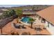 Desert landscape backyard with a pool, patio furniture, and mountain views creating a serene retreat at 8715 S Valley Vista Ct, Casa Grande, AZ 85193