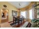 Inviting dining area with stylish rug, decorative lighting, and views of the backyard at 8715 S Valley Vista Ct, Casa Grande, AZ 85193