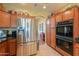 Bright kitchen featuring stainless steel refrigerator, oak cabinets, double oven, and tile flooring at 8715 S Valley Vista Ct, Casa Grande, AZ 85193