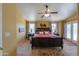 Spacious main bedroom with a ceiling fan, french doors, and decorative rug at 8715 S Valley Vista Ct, Casa Grande, AZ 85193