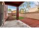 Cozy covered patio and blank canvas backyard with brick paved section at 924 E Redondo Dr, Gilbert, AZ 85296