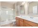 Bathroom featuring double sinks, a mirror, and a shower with glass door at 924 E Redondo Dr, Gilbert, AZ 85296