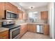 Well-appointed kitchen with stainless steel appliances and tile backsplash at 924 E Redondo Dr, Gilbert, AZ 85296