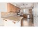 Well-lit kitchen with stainless steel appliances, light wood cabinetry and tile countertops at 924 E Redondo Dr, Gilbert, AZ 85296