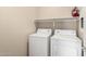 Bright laundry room with washer, dryer and overhead shelving at 924 E Redondo Dr, Gilbert, AZ 85296