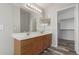 Bathroom featuring a double vanity sink, ample counter space, and wood-look flooring at 9423 E Posada Ave, Mesa, AZ 85212