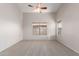 Spacious bedroom with neutral carpet, a ceiling fan, and natural light from the window at 9423 E Posada Ave, Mesa, AZ 85212