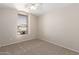 Bedroom with a ceiling fan, neutral carpet, and a window providing natural light at 9423 E Posada Ave, Mesa, AZ 85212