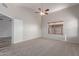 Bright bedroom featuring neutral tones, carpet, and a ceiling fan, offering a serene space at 9423 E Posada Ave, Mesa, AZ 85212