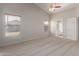 Vaulted ceiling bedroom with carpet, natural light, and views of an ensuite bathroom at 9423 E Posada Ave, Mesa, AZ 85212