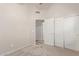 Bedroom featuring closet with sliding doors and neutral carpet at 9423 E Posada Ave, Mesa, AZ 85212