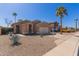 Inviting single-story home featuring desert landscaping and a convenient two-car garage at 9423 E Posada Ave, Mesa, AZ 85212