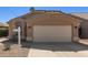 Close up of the garage door of a charming single-story home with desert landscaping at 9423 E Posada Ave, Mesa, AZ 85212