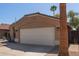 Attached garage to a single story home, featuring a low-pitched tile roof at 9423 E Posada Ave, Mesa, AZ 85212