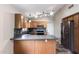 Functional kitchen with wood cabinets, stainless steel appliances, and tile backsplash, offering a modern cooking space at 9423 E Posada Ave, Mesa, AZ 85212