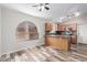 Bright kitchen area featuring oak cabinetry, a modern countertop, and views of the backyard at 9423 E Posada Ave, Mesa, AZ 85212