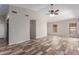 Bright and airy living room with wood-look flooring, neutral walls, and ceiling fan at 9423 E Posada Ave, Mesa, AZ 85212