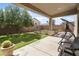 Outdoor covered back porch featuring concrete flooring and lawn and shrubbery views at 10721 E Pampa Ave, Mesa, AZ 85212