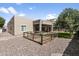 Tan single-story house with covered patio and graveled backyard at 10721 E Pampa Ave, Mesa, AZ 85212