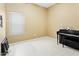 Versatile spare bedroom with a piano, suitable for use as a music room or a quiet retreat within the home at 10721 E Pampa Ave, Mesa, AZ 85212