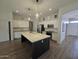 Modern kitchen boasts a large island with quartz countertops, stainless steel appliances and white cabinets at 10721 E Pampa Ave, Mesa, AZ 85212