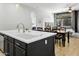 Open-concept kitchen with a large island that has a sink, seamlessly connecting to the dining and living areas at 10721 E Pampa Ave, Mesa, AZ 85212