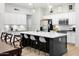 Modern kitchen boasts white cabinets, stainless steel appliances, and a large island with marble countertops at 10721 E Pampa Ave, Mesa, AZ 85212
