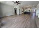 Open-concept living space with wood-look floors seamlessly connecting the living, dining, and kitchen areas at 10721 E Pampa Ave, Mesa, AZ 85212