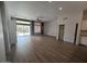 Spacious living area with wood-look flooring, sliding doors to the backyard, and convenient built-in storage at 10721 E Pampa Ave, Mesa, AZ 85212