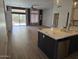 Bright living room featuring hardwood floors, sliding glass doors to the backyard, and a modern ceiling fan at 10721 E Pampa Ave, Mesa, AZ 85212
