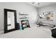 Workout room with a treadmill, exercise equipment, and a large mirror, illuminated by natural light from the window at 10721 E Pampa Ave, Mesa, AZ 85212